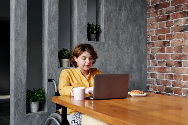 Woman in a wheelchair working on a laptop