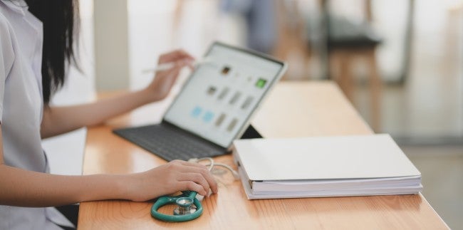 Nurse using AI technology on iPad