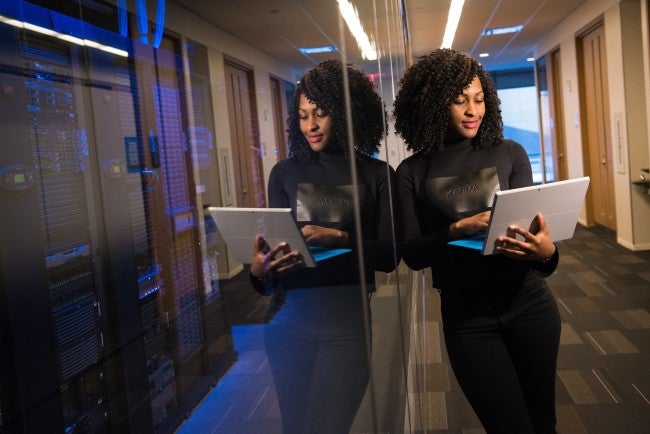Woman in hallway working on computer