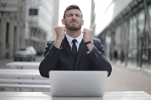 Man at a laptop on a city street