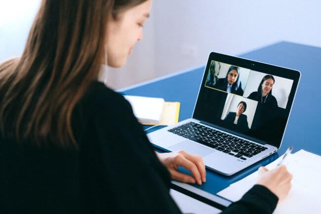 Woman sitting in front of laptop on video meeting