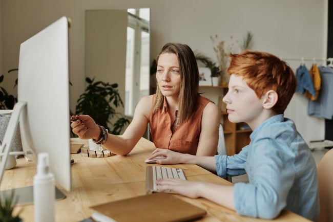 Mom and son doing online school