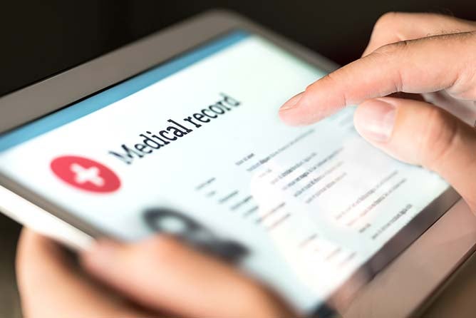 Image of a tablet with medical information on the screen.