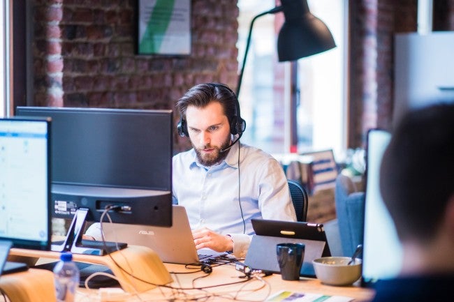 Man with headset working on computer