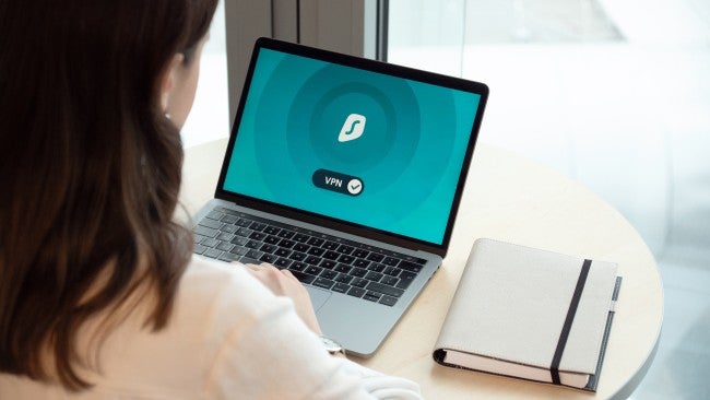 Woman using VPN on laptop for cybersecurity