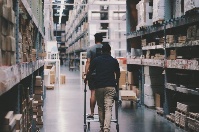 Men walking through warehouse