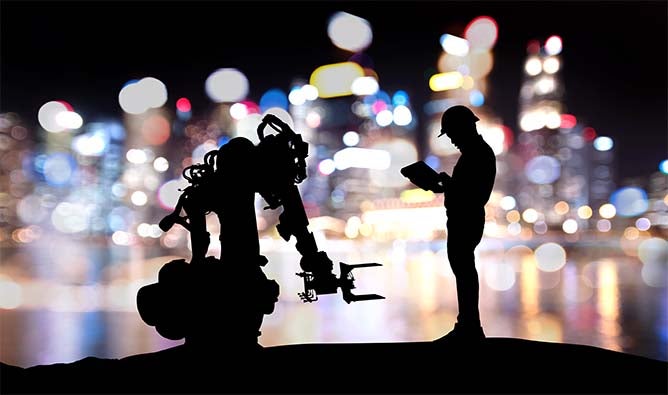 A sillhouette of a man and a robot stand in front of a lit city skyline.