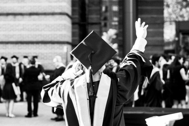 Student in college cap and gown for graduation
