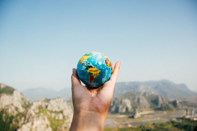 Hand holding small globe - gap year