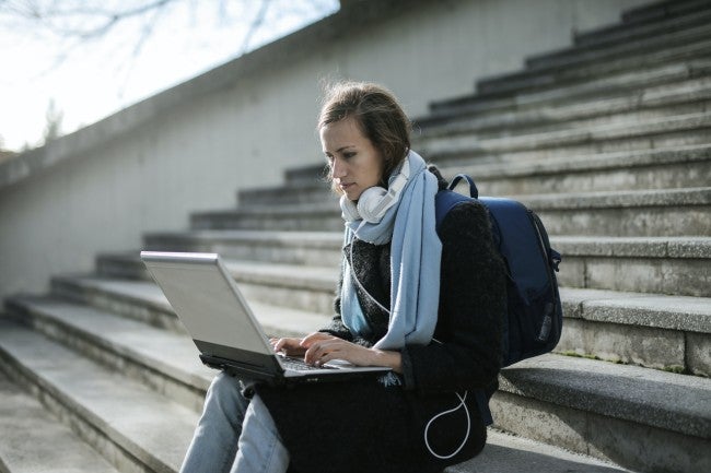 Woman doing online school outside