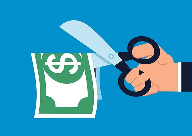 Illustration of a hand holding scissors about to cut a dollar bill in half.