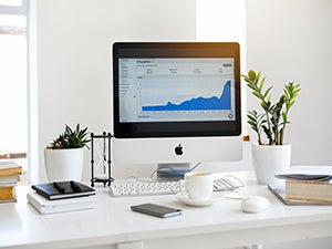 image of desktop computer displaying marketing metrics
