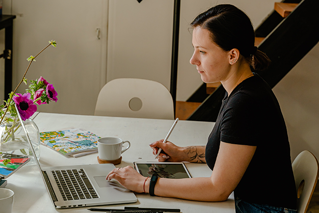 woman writing and learning at computer