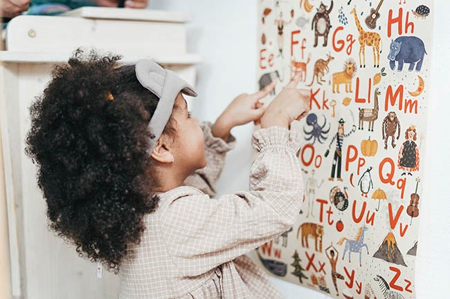 Girl points out alphabet