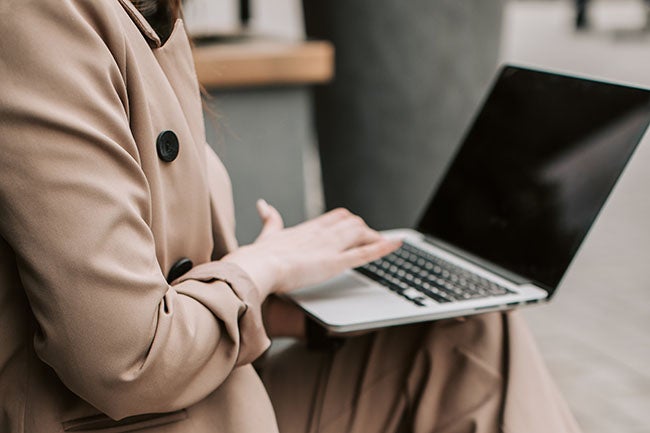 business plan statement of purpose example typing on laptop in tan coat