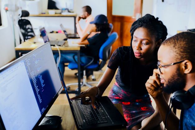 adult learners looking at a computer
