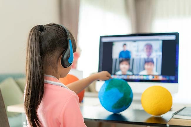 A young girl gives a virtual presentation about the solar system.