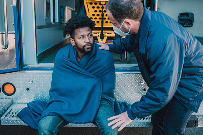 Man Being Helped by Paramedics