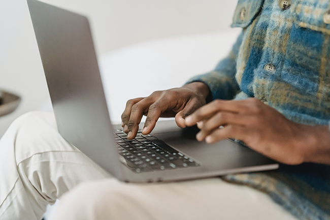 man typing on computer