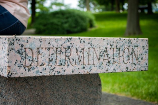 Granite bench engraved with the word "determination"