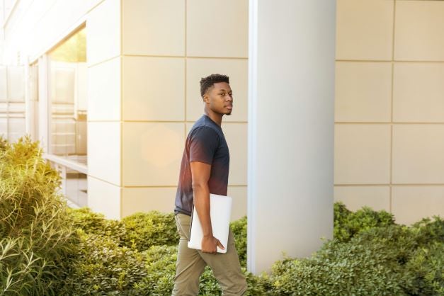 Black student walking into building