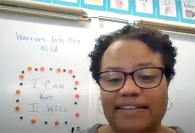 Justine pictured in front of a white board
