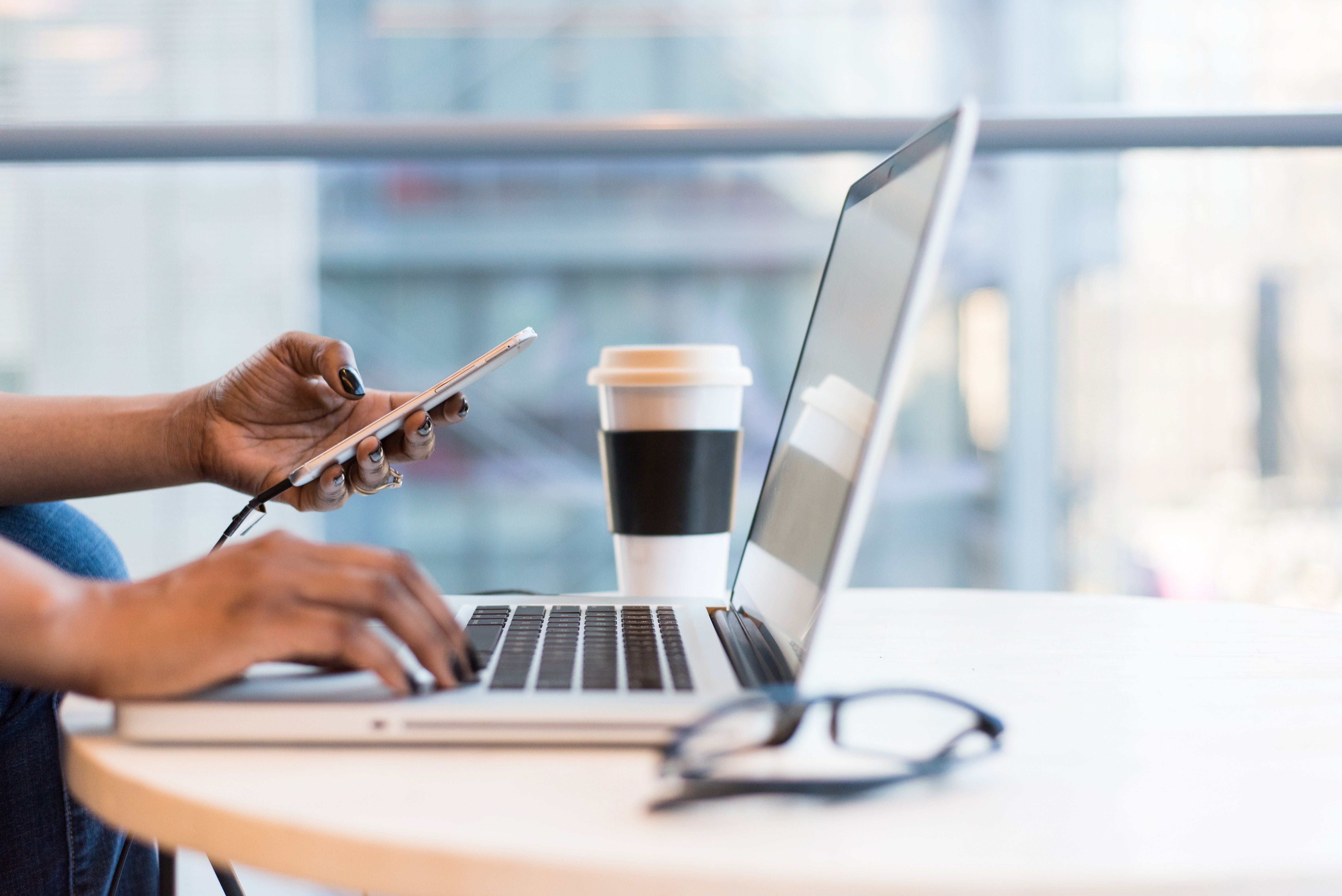 person sitting on the floor looking at a laptop