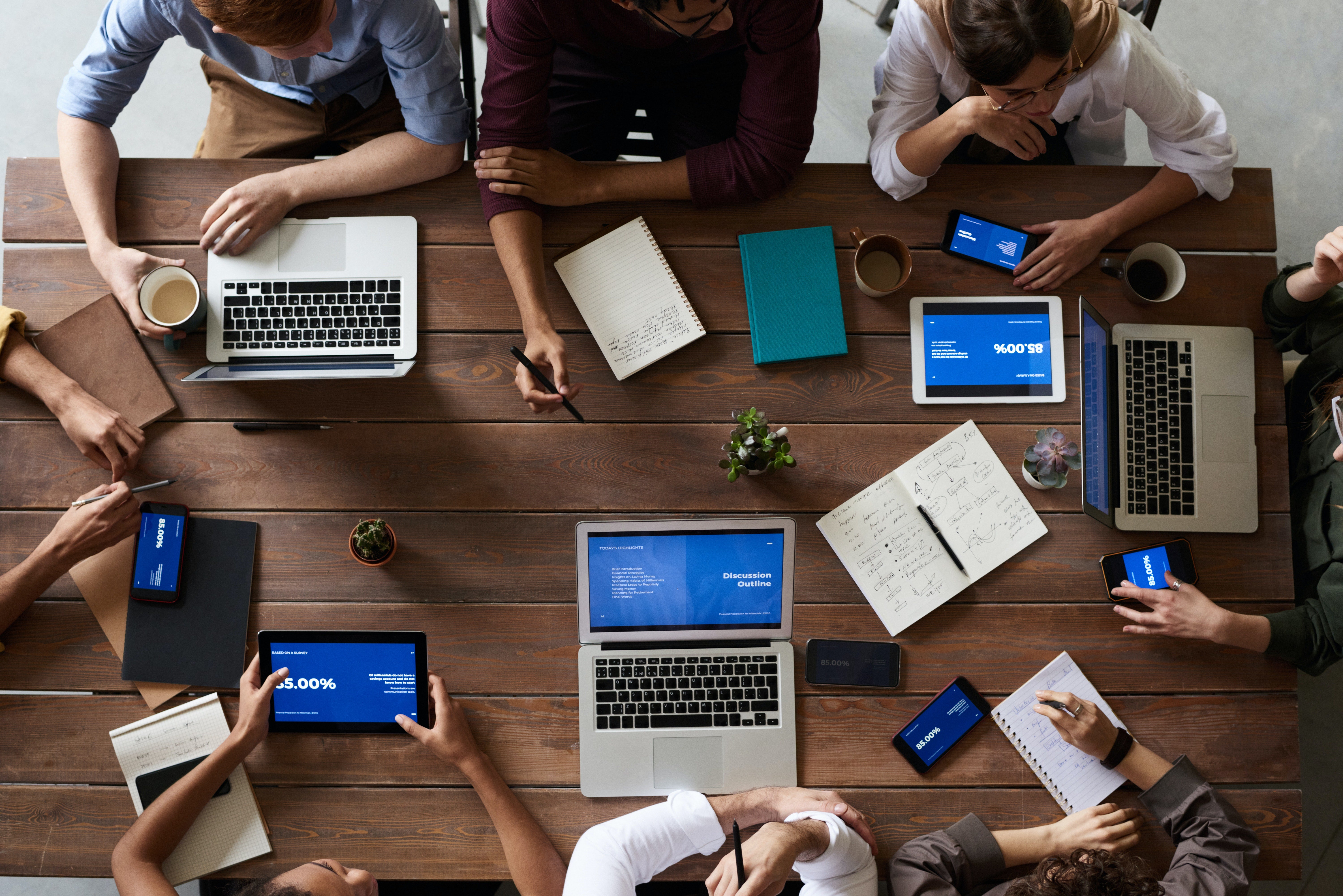 people working at a table with laptops