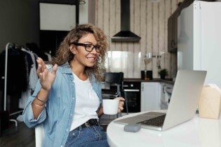 Person reacting to something they are watching on a laptop