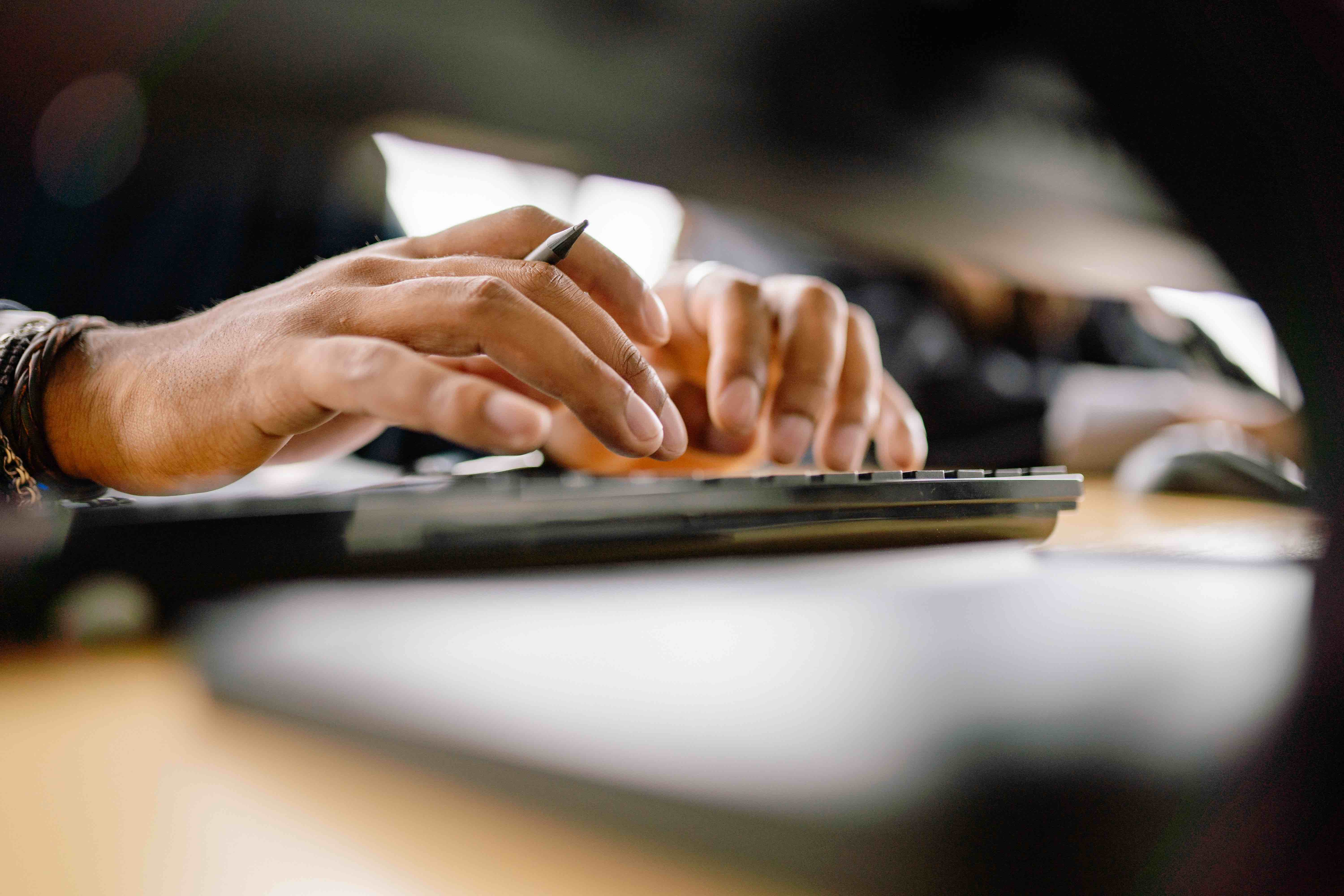 close up images of hands typing on a keyboard