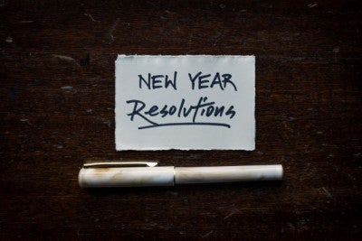 Pen and paper saying "New Year Resolutions"