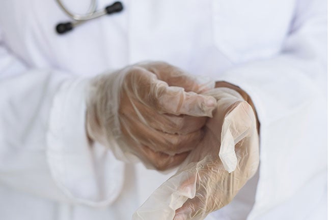 nurse putting on gloves