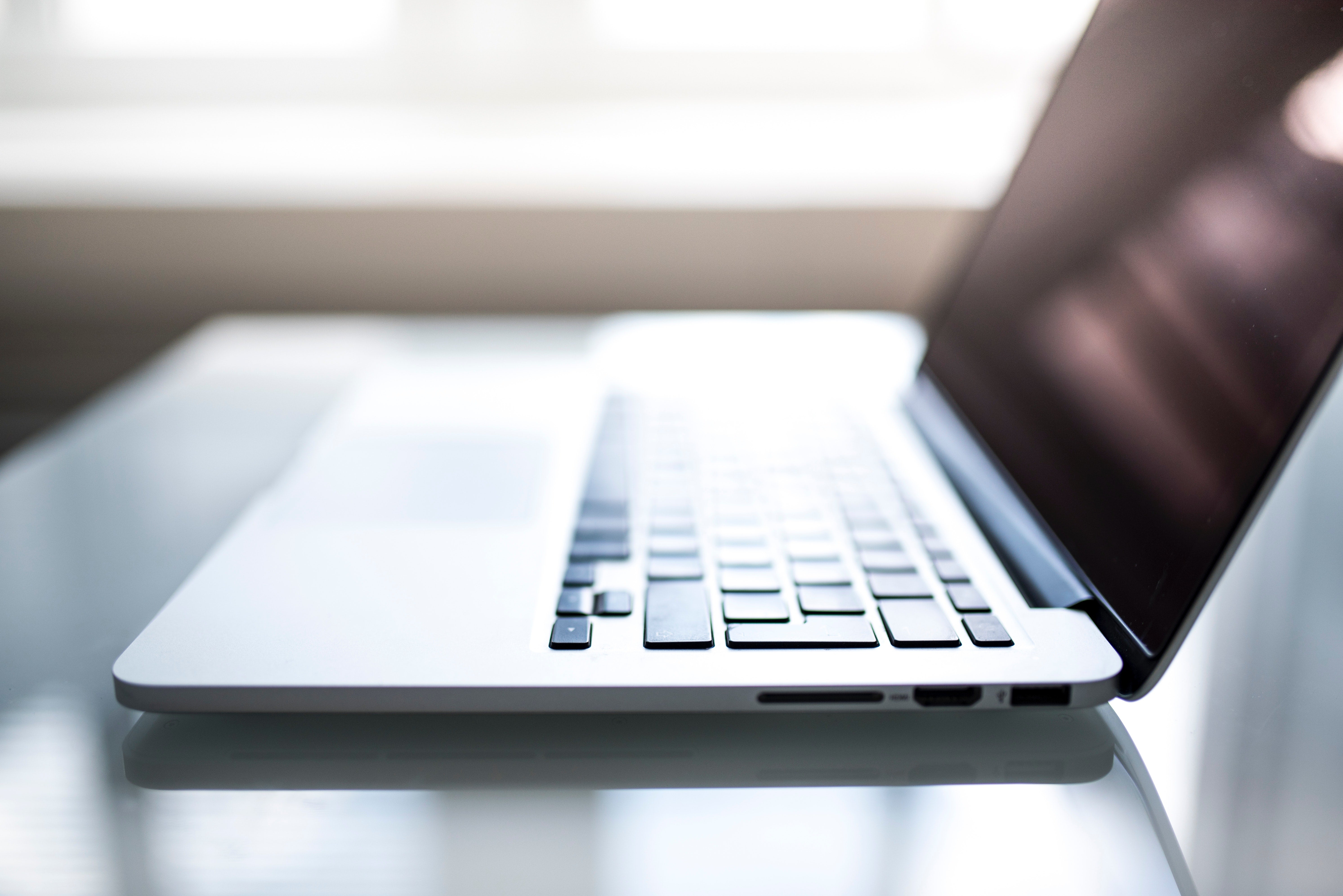 close-up of an open laptop sitting on a desk