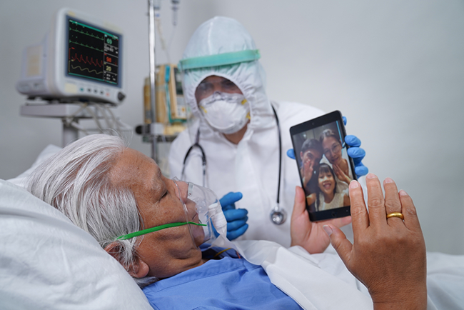 nurse helping patient talk to family