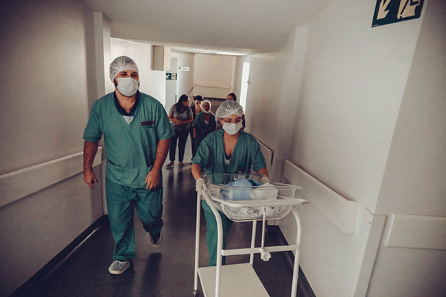 nurses walking with baby