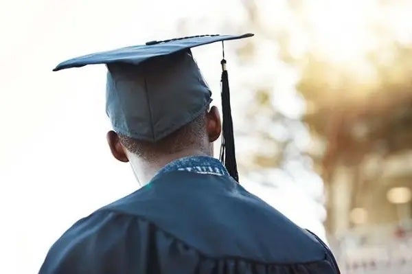 person standing in a graduation cap and gown