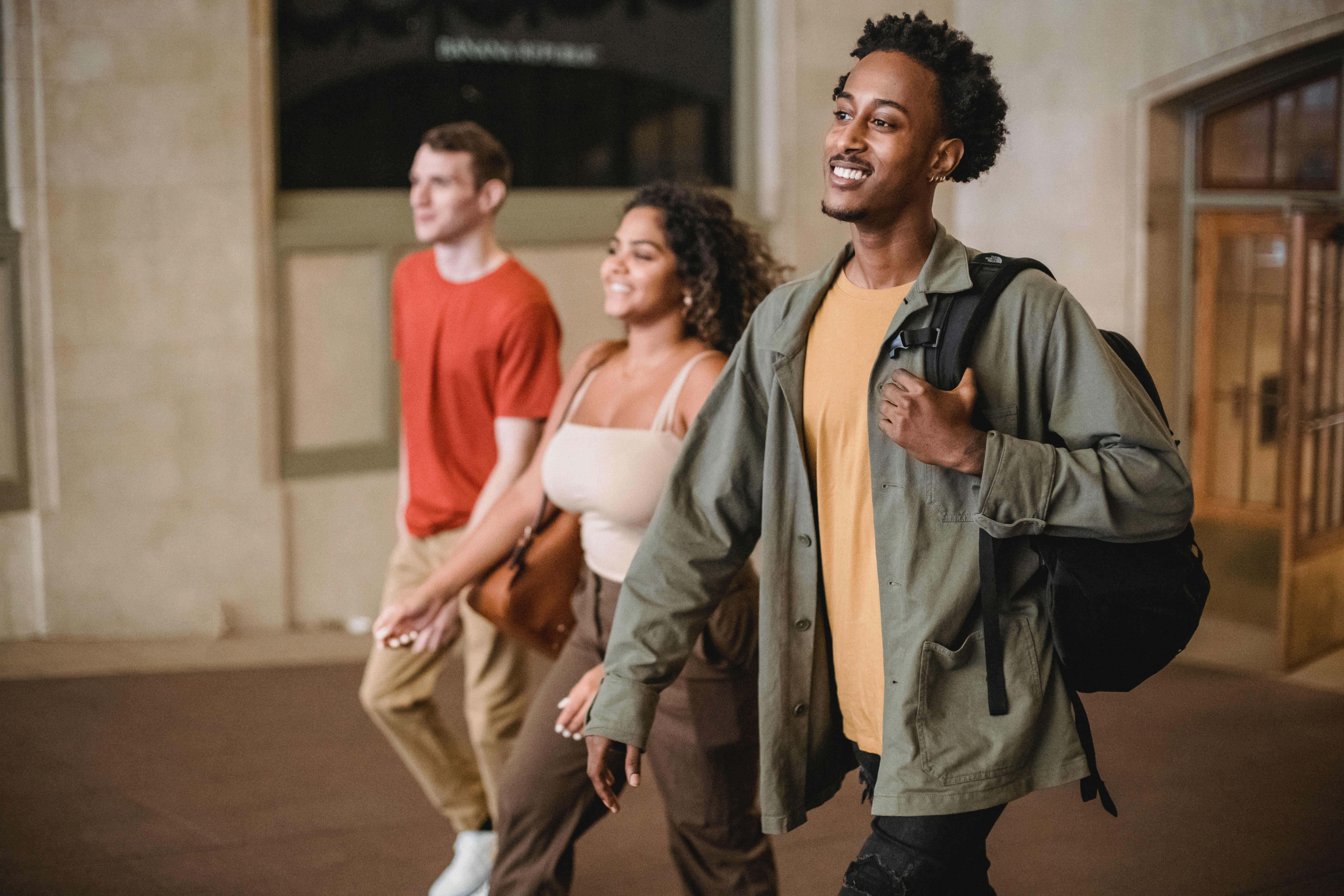 three people walking into a room