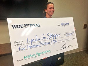 lynda holding a big old check