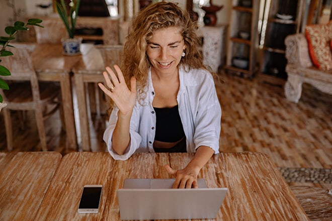Woman saying hello via videoconference