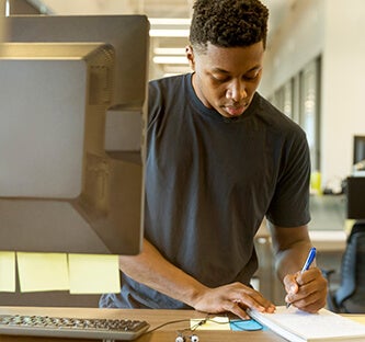 African American student taking notes