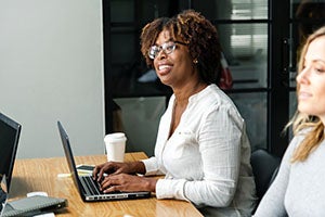 Woman at a laptop in a meeting