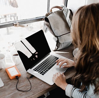 Woman using a laptop in a coffee shop