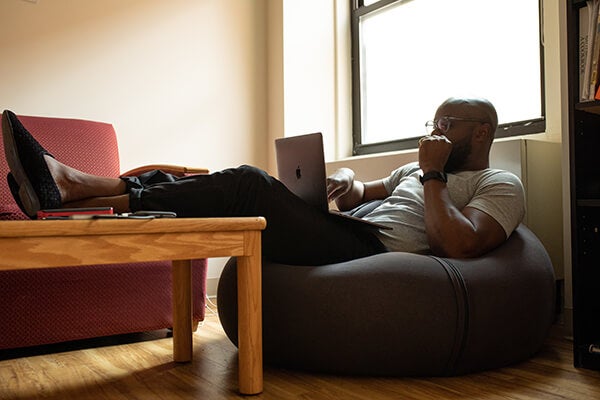 Man on a beanbag with a laptop