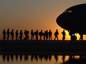 Military members boarding a plane