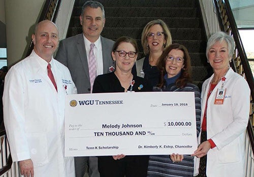 Melody Johnson receives scholarship check