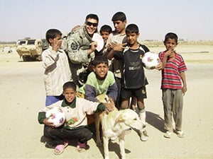 Jason Sims poses with a group of young boys