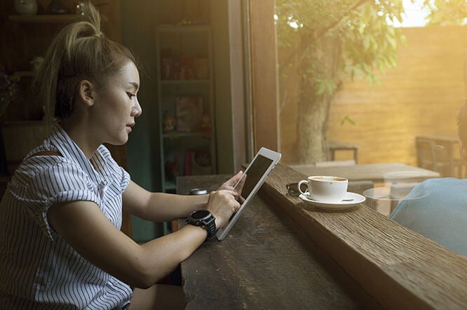 Woman using a tablet in a coffee shop