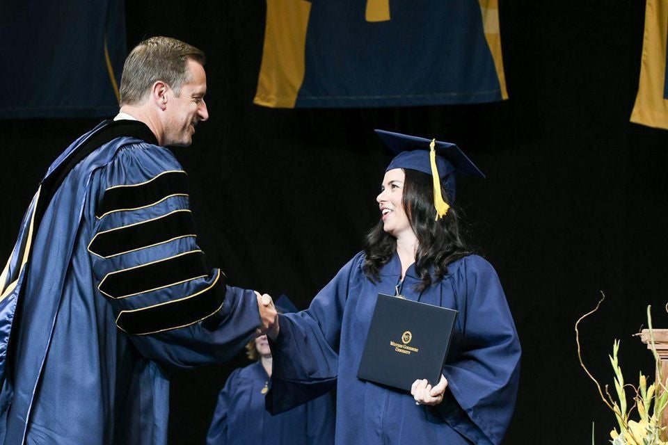 WGU President Scott Pulsipher Shaking the Hand of a Woman WGU Graduate