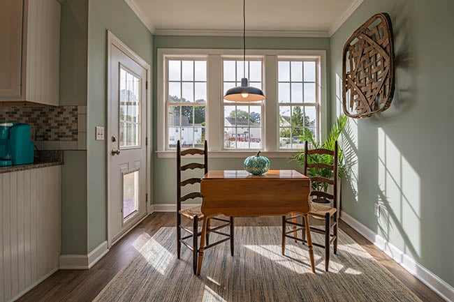 dining room with windows in the back
