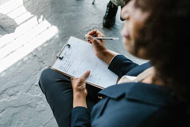 taking notes on clipboard